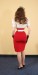 Back view of Annalai wearing a white shirt and red skirt